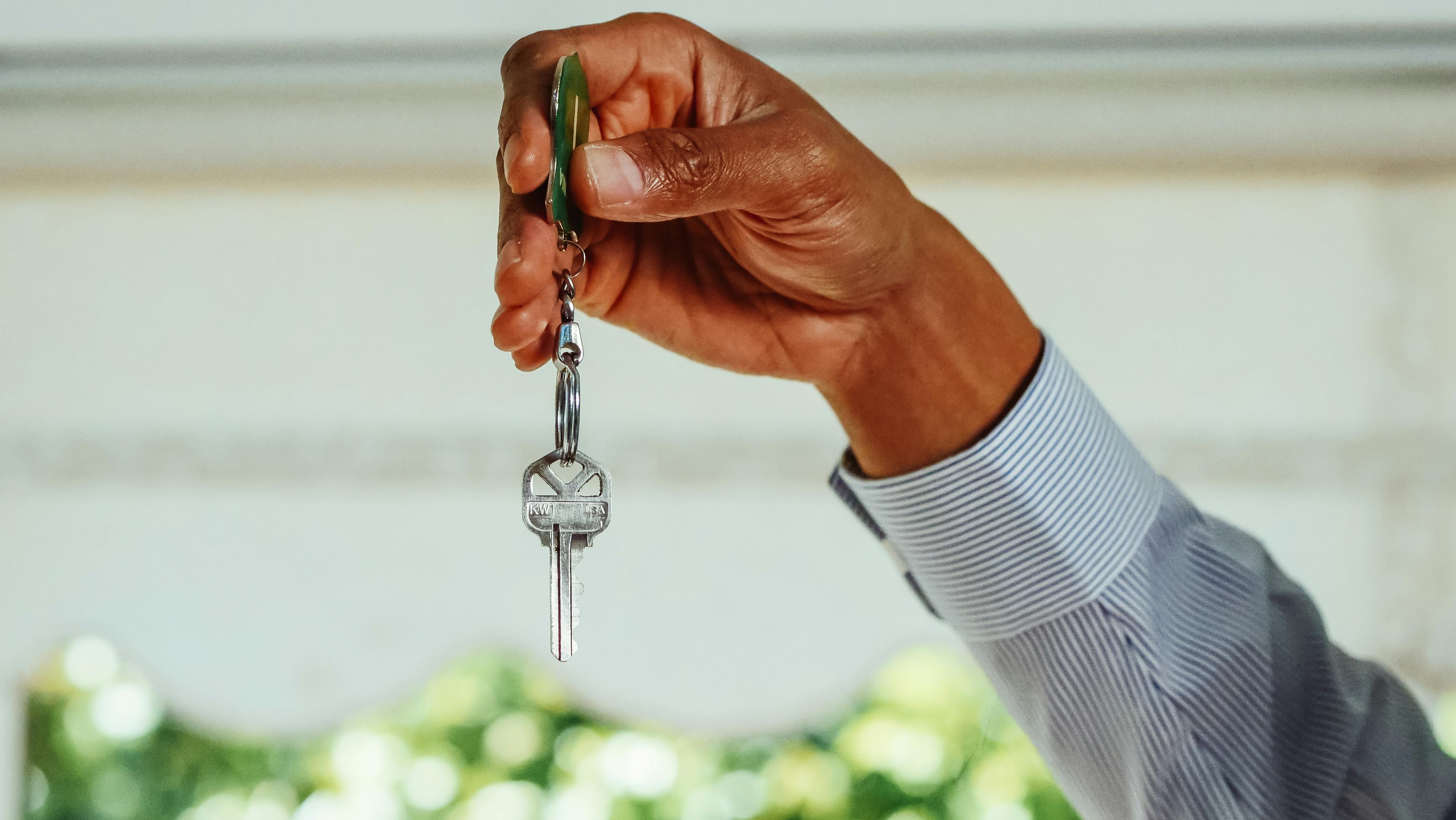 Hand holding a set of keys, symbolizing access to a new home or property managed by RentMate